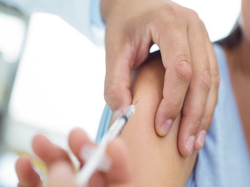 Doctor giving an injection to the patient at hospital